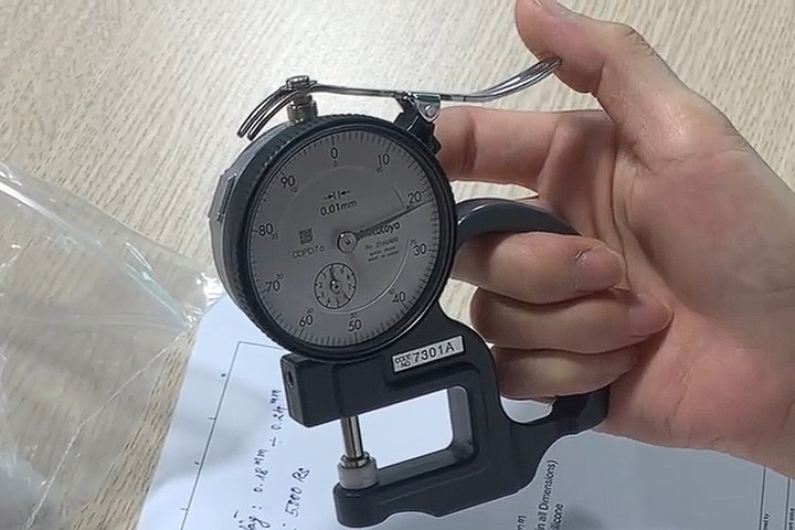 The precision dial gauge captures a reading of 0.218mm, demonstrating our capability to stay well within the 0.21±0.03mm target range.